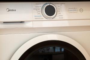 a white washing machine with its door open at Athensis Acropolis View next to Ermou street! in Athens