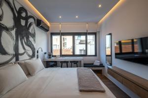 a bedroom with a large bed and a sink in it at Athensis Acropolis View next to Ermou street! in Athens