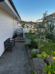 een veranda met een bank aan de zijkant van een huis bij Lovely home in maritime surroundings near Stavanger in Stavanger
