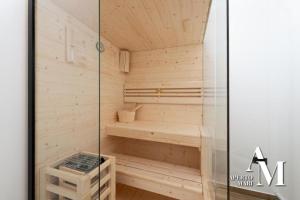 a sauna with a bench and a glass door at Gorska Idila "Smreka" - a Modern House in Quiet Area with Wellness in Stari Laz
