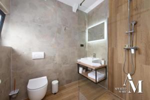 a bathroom with a shower and a toilet and a sink at Gorska Idila "Smreka" - a Modern House in Quiet Area with Wellness in Stari Laz +7 photos