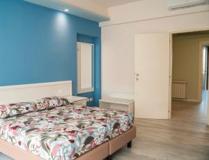 a bedroom with a bed and a blue wall at Sogna Firenze apartments in Florence