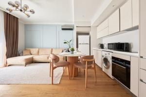 a kitchen and living room with a table and a couch at Taksim Lagirio Residence in Istanbul