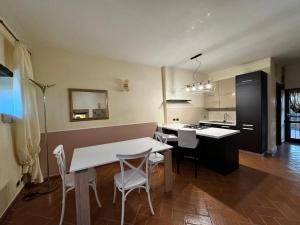 a kitchen with a table and chairs in a room at AL CARDINALE in Fondi