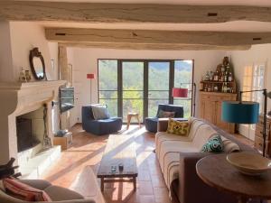 a living room with a couch and a fireplace at La Bergerie in Bargemon