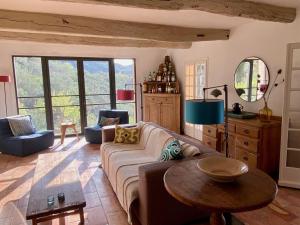 a living room with a couch and a table at La Bergerie in Bargemon