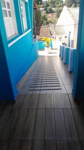 a blue house with a wooden floor and a balcony at Blue House in Lençóis