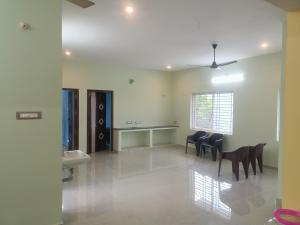 a room with chairs and a table and a sink at Mani Kasthuri Illam in Tiruvannāmalai
