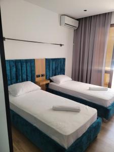 Voodi või voodid majutusasutuse Apollonia Hotel toas