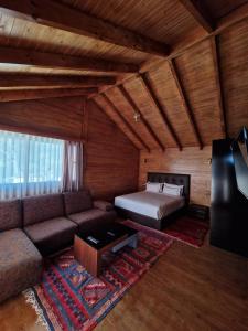 a living room with a couch and a bed at Mnar Park aqua park in Tangier