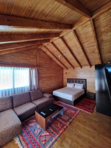 a living room with a couch and a bed at Mnar Park aqua park in Tangier
