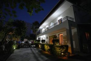 a group of people sitting outside of a building at night at Villa Qeli in Gjirokastër +40 photos