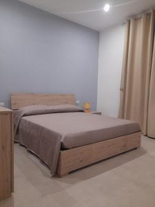 a bedroom with a bed in a white room at Apartment Emanuela in Porto Cesareo