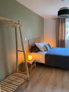 ein Schlafzimmer mit einem Bett mit einer Leiter und einer Lampe in der Unterkunft La Clé des Champs Maison familiale à 15min Disneyland Paris WIFI GRATUIT in Boutigny