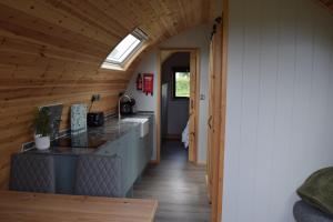 a kitchen with a long hallway with a skylight at Oakwood Escapes in North Cliff +11 photos