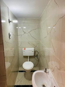 a bathroom with a toilet and a sink at Vasu guest house in Amritsar +10 photos