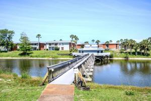 a boat is docked at a dock on a river at Eden Escape Lake View 3 Pools Pet Friendly in Destin