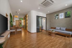 a living room with a couch and a table at Q Apartment Da Nang in Danang