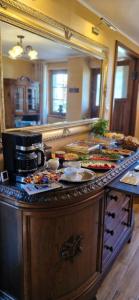 a kitchen with a counter with food and a mirror at Szachulcowa Zagroda in Ustka