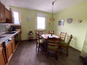 a kitchen with a table and chairs in it at Regenbergblick in Zella-Mehlis