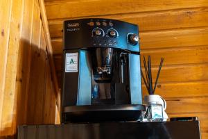 a black coffee maker sitting on top of a counter at Cabana VP in Alunişu