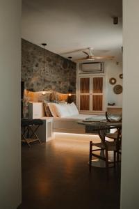 a bedroom with a bed and a table with chairs at Venue Villas - Folegandros in Áno Meriá