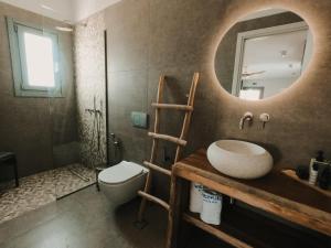 a bathroom with a sink and a mirror at Venue Villas - Folegandros in Áno Meriá