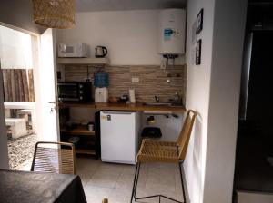 a kitchen with a white refrigerator and two chairs at vivestadias in San Gregorio +11 photos