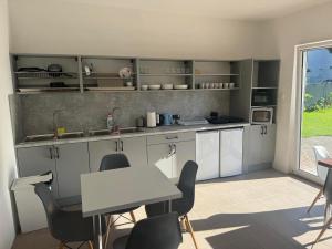 a kitchen with white cabinets and a table and chairs at Costa Mielno in Mielno +42 photos
