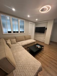 a living room with a couch and a flat screen tv at Bella Mela in Tuzla