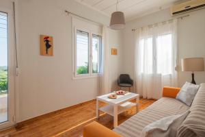 a living room with a couch and a table at Country House Pidasos in Pídhasos