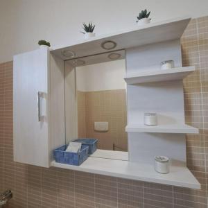 a mirror in a bathroom with a sink at Alma Lake in Bellano