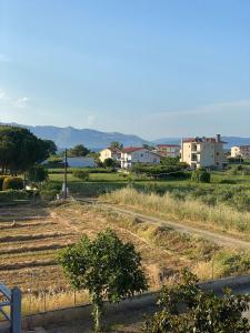 a view of a field with houses in the background at Pefki Apartment 4 in Artemísion