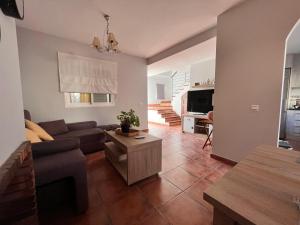 a living room with a couch and a table at Casa con piscina en Málaga in Sierra de Yeguas