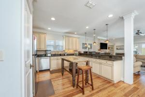 a kitchen with a large island in a room at Yellow Pearl Pool heat GolfCart deals Steps2Beach in Destin
