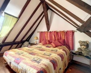 a teddy bear sitting on a bed in a room at L'Escale Tourangelle in Saint-Georges-sur-Cher