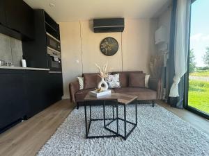 a living room with a couch and a table at Logement cosy indépendant avec jardin et Parking in Cornillé