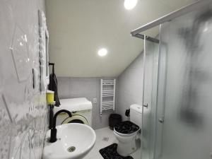 a small bathroom with a sink and a toilet at Guest House Natia in Tbilisi City