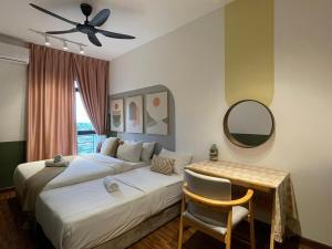 a bedroom with a bed and a table and a mirror at K Avenue Kota Kinabalu in Donggongon