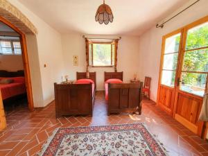 a living room with two beds and a rug at Podere Il Cardellino in Lari