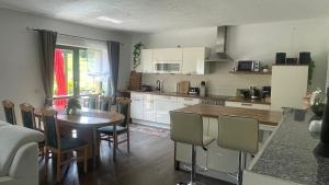 a kitchen with a table and a dining room at Ferienwohnung am Chursbach in Callenberg +25 photos