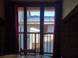 an open window with a view of a balcony at Le charme montagnard in Barcelonnette
