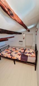 a bedroom with a bed with logs on the ceiling at Appartement plein centre-ville in Lodève