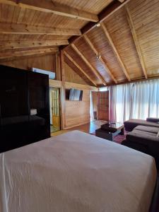 a bedroom with a white bed and a couch at Mnar Park aqua park in Tangier