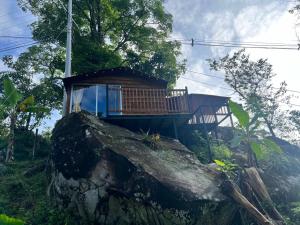 a small house on top of a large rock at Mirador del Padre in Gómez Plata