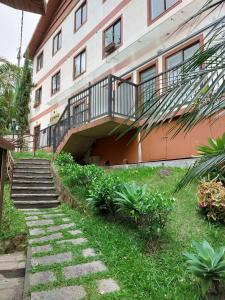 a building with stairs and a balcony on it at Ecoapê in Petrópolis