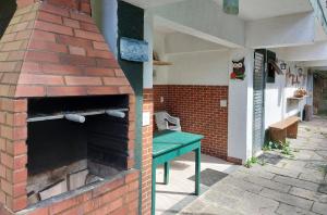 an outdoor brick oven with a green table in it at Ecoapê in Petrópolis +11 photos
