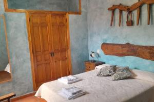 a bedroom with a bed with two towels on it at Casas Rurales Mi Reja B in Santa María de Riaza