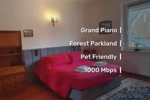 a bedroom with a red bed with a red blanket at Le fourneau des pianistes in Nilvange