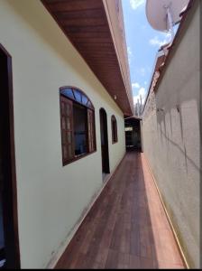 an empty hallway of a building with a window at Casa vila do serrano in São Bento do Sapucaí